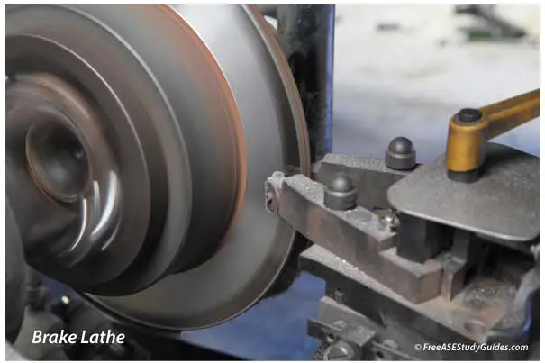 Brake rotor is machined on a brake lathe.