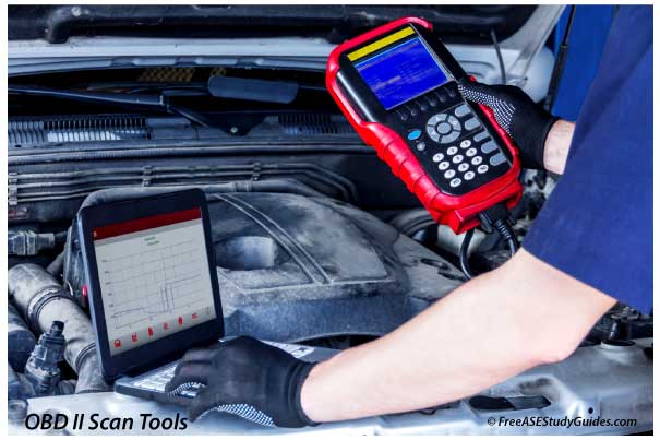 Automotive technician using OBD2 scan tool.